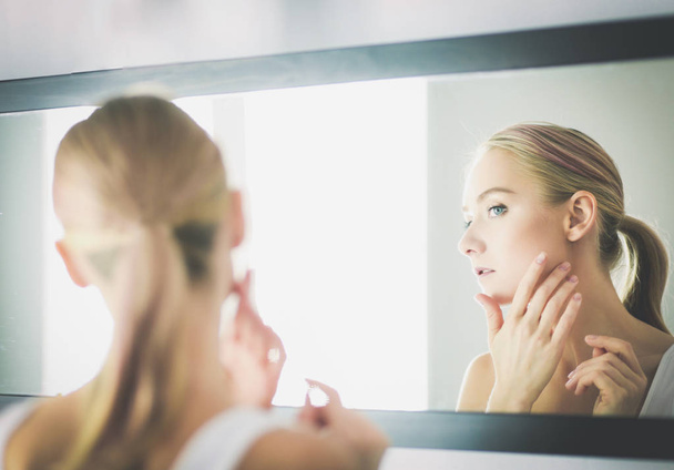 face of young beautiful healthy woman and reflection in the mirror - Foto, Imagen