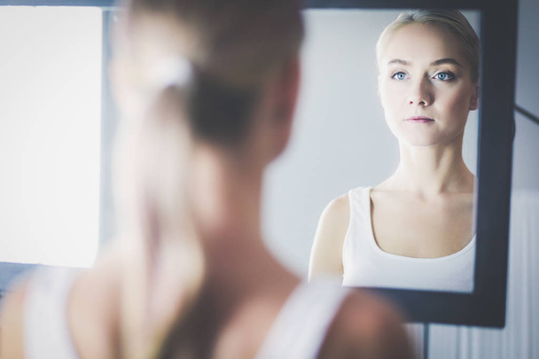 face of young beautiful healthy woman and reflection in the mirror - Foto, imagen