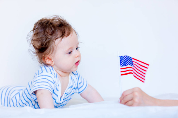 Little child boy with blue eyes and american flag - 写真・画像