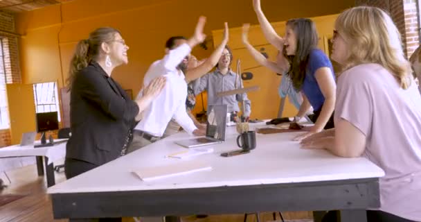 Collaborative startup business team of mostly women celebrate with high fives - Footage, Video