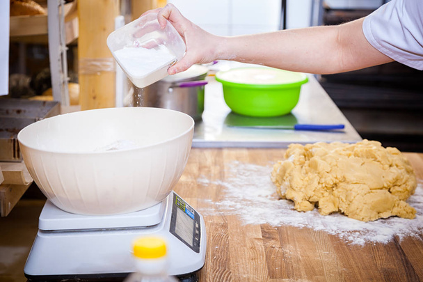 baker pouring white flour  - Photo, Image
