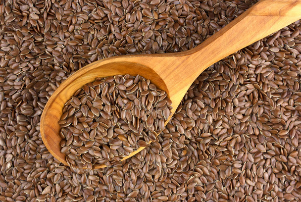 Flax seeds in wooden spoon background.  - Photo, Image