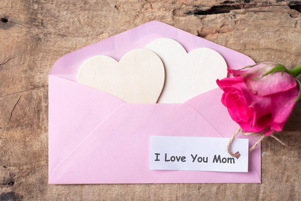 Pink envelope, heart and pink rose with I Love You Mom tag card in Mother's day - Photo, Image