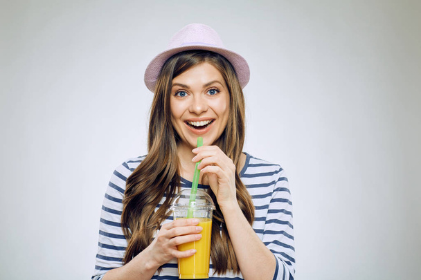 beautiful woman in hat drinking orange juice  - Fotó, kép