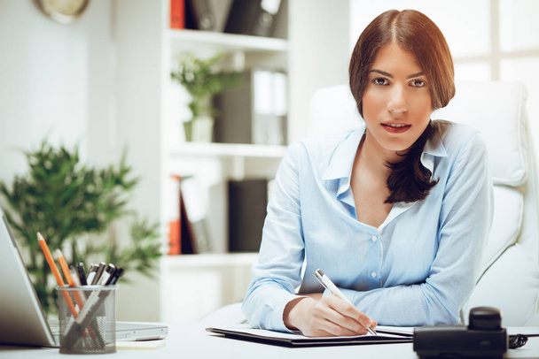 young businesswoman working at desk in office - Photo, Image