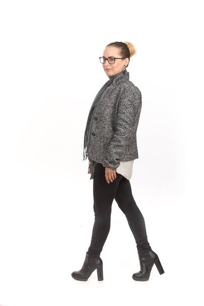 A girl in demi-season clothes with a full-length on a white background. - Photo, Image