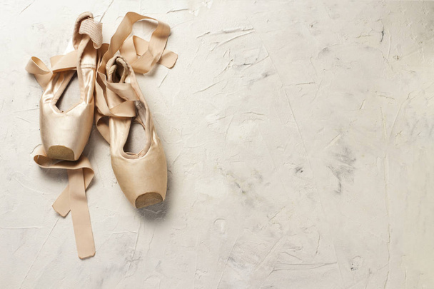 Pointe ballet shoes light stone background. Concept of ballroom  - Photo, Image