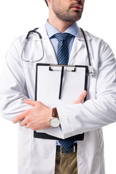 Close-up view of blank clipboard in hands of doctor wearing white coat with stethoscope isolated on white - Photo, Image