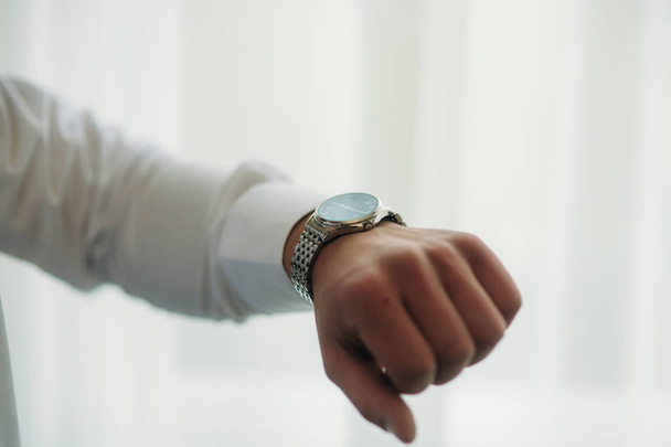 Hand with watch. groom in wedding morning - Фото, изображение