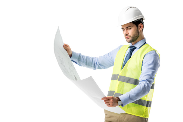 Thoughtful builder in reflective vest looking at blueprint isolated on white - Photo, Image