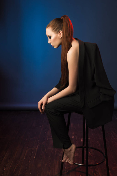 High fashion portrait of young elegant woman in black suit. - Фото, изображение