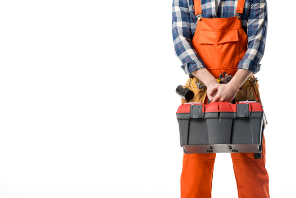 Cropped view of workman in orange overall holding tool box isolated on white - Fotoğraf, Görsel