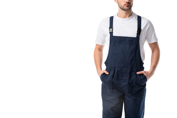 partial view of cleaner in uniform with hands in pockets isolated on white - 写真・画像