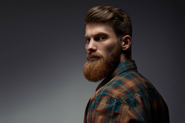 Guy with a red beard in a plaid shirt - Foto, imagen