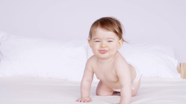 Cheerful baby crawling at bedroom  - Footage, Video