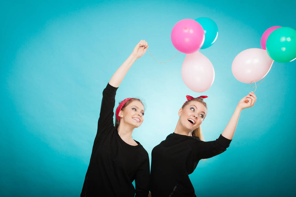 Women like a little girls want fly away by balloons. - Фото, зображення