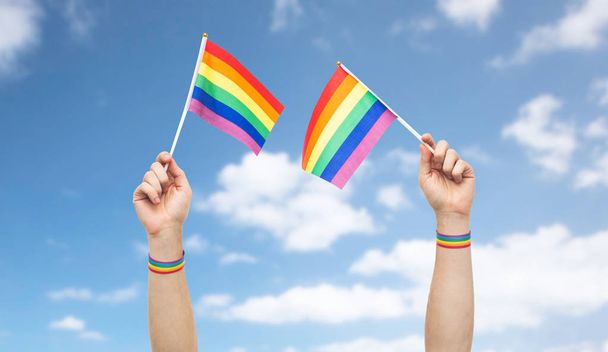 hand with gay pride rainbow flags and wristbands - Φωτογραφία, εικόνα