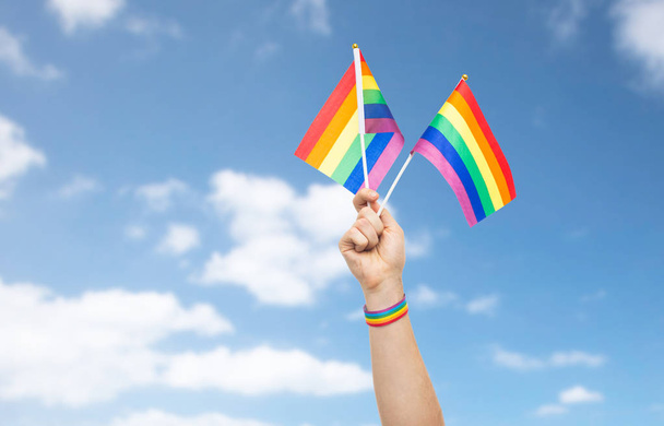 hand with gay pride rainbow flags and wristband - Φωτογραφία, εικόνα