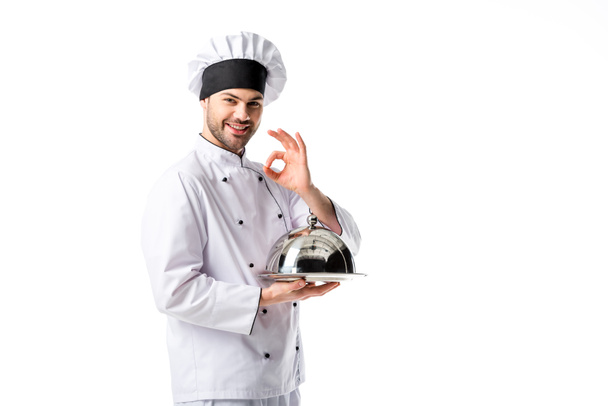 smiling chef with serving tray showing ok sign isolated on white - Foto, Bild