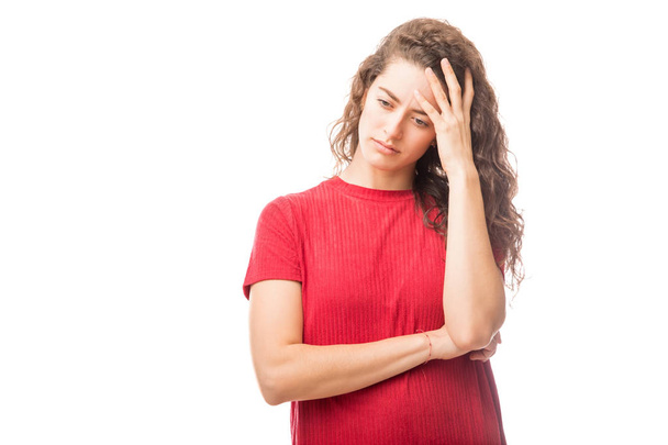 Young caucasian woman standing with her hand on head and looking down with upset expressions isolated on white background - Photo, image