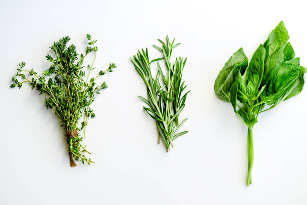 bunches of tied thyme and rosemary with basil herbs isolated on white background, close-up  - Foto, immagini