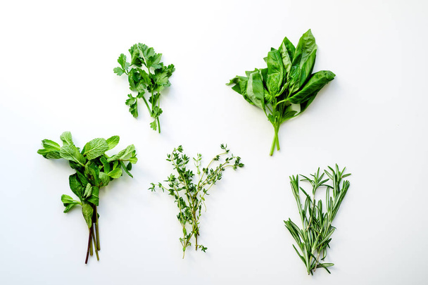 bunches of rosemary with thyme and mint with basil and parsley herbs isolated on white background, close-up  - 写真・画像