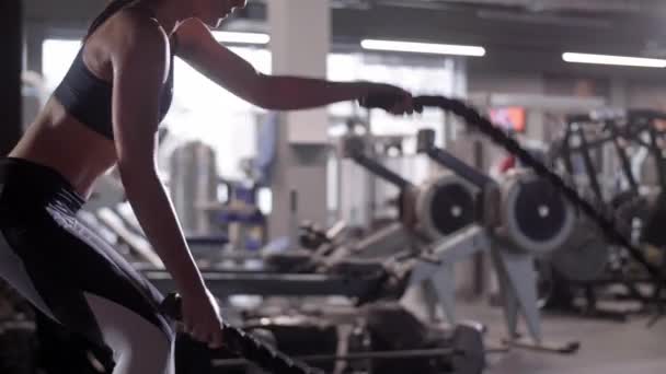 Athlete with ropes exercising at gym  - Video