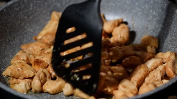 Κομμάτια από φιλέτο κοτόπουλο τηγανισμένο σε ένα τηγάνι - Πλάνα, βίντεο