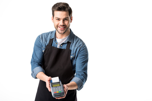 portrait of smiling waiter in apron with cardkey reader isolated on white - Photo, Image