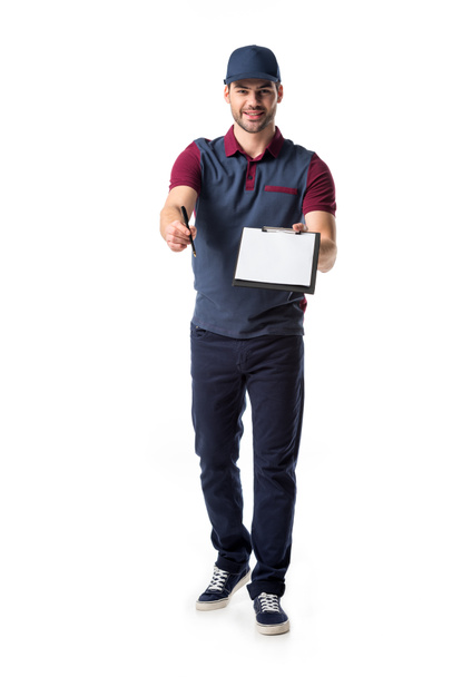 smiling delivery man with empty notepad and pen isolated on white - Photo, Image