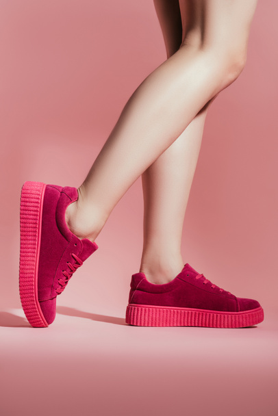 cropped shot of girl in stylish sneakers on pink background - Photo, Image
