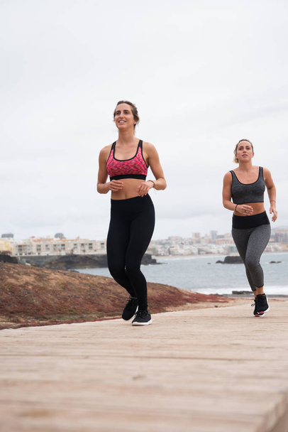 Young attractive females running   - 写真・画像