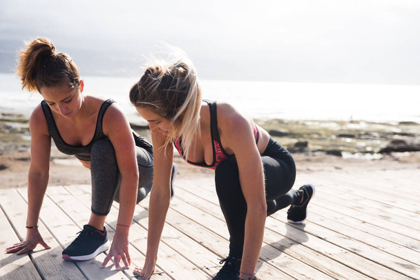 young women exercising together  - Фото, изображение