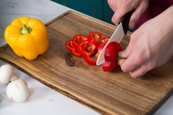 Preparing food, chef cutting red bell pepper. - Photo, image