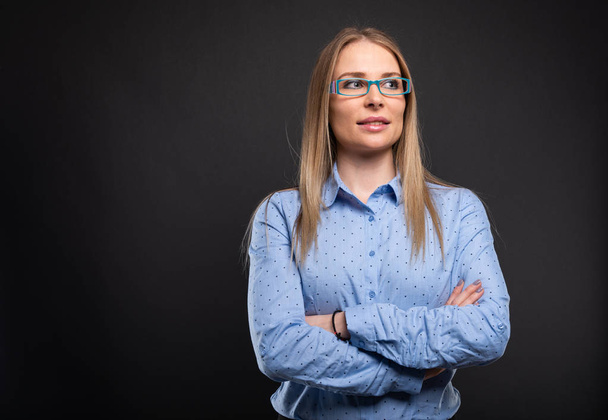 Business lady wearing blue glasses standing with arms crosse - Foto, Bild