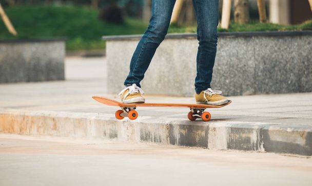 Skateboarder riding skateboard going down the step - Foto, Bild