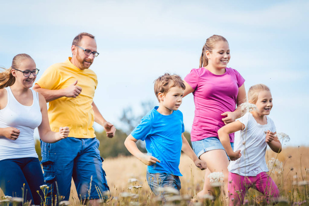 Family running for better fitness in summer - Foto, immagini