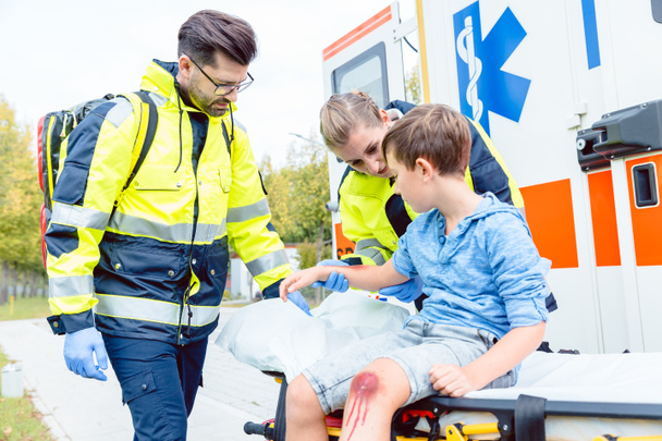 Emergency doctors caring for accident victim boy - Photo, Image