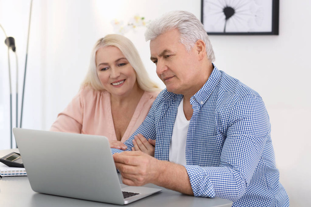 Mature couple thinking over pension payment at home - Valokuva, kuva
