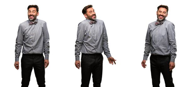 Middelbare leeftijd man, met baard en strikje uitsteken van de tong op camera bij teken van ongehoorzaamheid, protest en gebrek aan respect - Foto, afbeelding