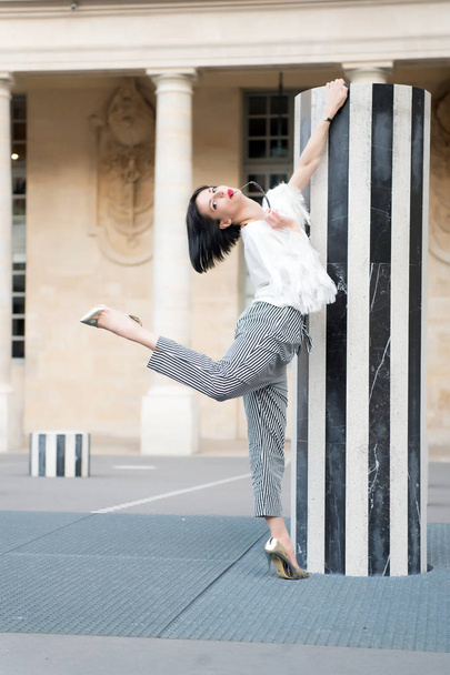 Beauty woman pose in paris, france. Beauty model pose in high heel shoes at column - Photo, Image