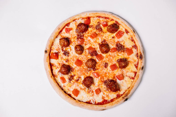 Pizza with meatballs and tomato isolated on white. Top view - Foto, afbeelding