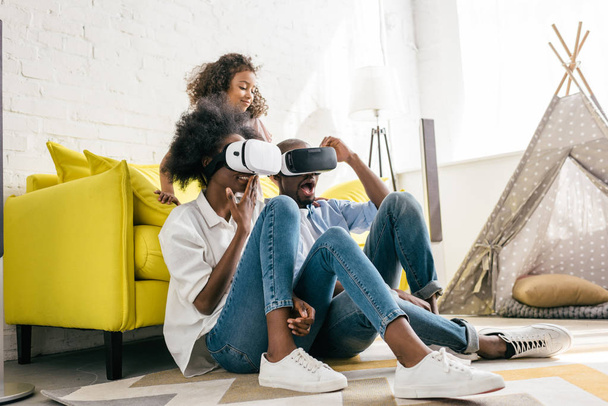 african american in virtual reality headset having fun together at home - Foto, immagini