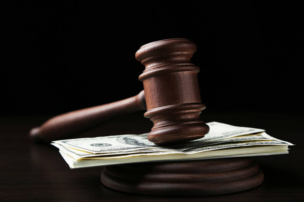 Judge gavel with dollars on wooden table - Foto, Imagen