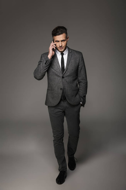 Full-length photo of concentrated man 30s dressed in businesslik - Photo, image