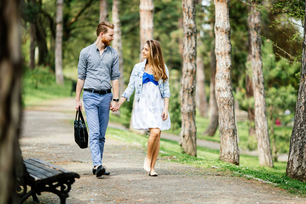 Beautiful couple taking a walk in  city park - Zdjęcie, obraz
