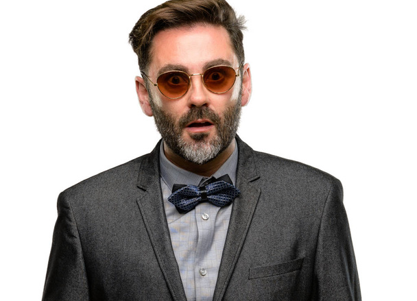 Middle age man, with beard and bow tie scared in shock, expressing panic and fear isolated over white background - Foto, immagini
