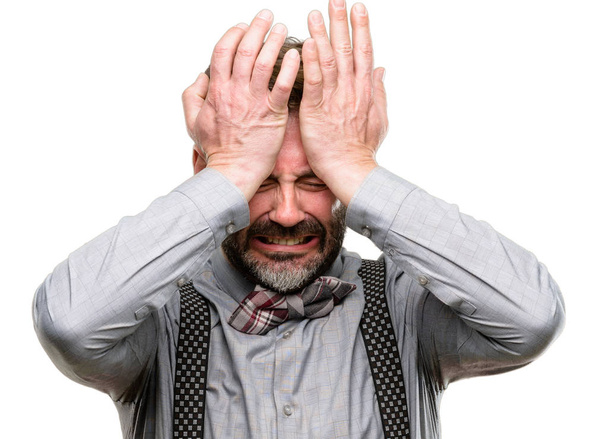 Middle age man, with beard and bow tie terrified and nervous expressing anxiety and panic gesture, overwhelmed isolated over white background - Photo, Image
