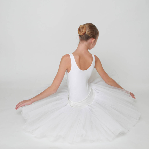 Beautiful little ballerina in studio - Фото, зображення
