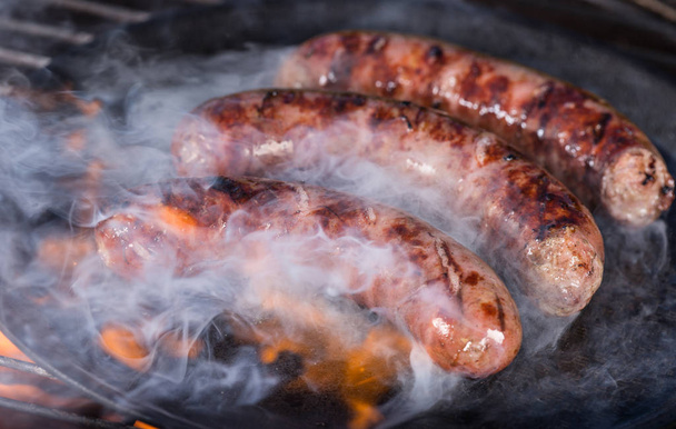 Barbecue grill with sausages in cast iron pan.p. - Foto, Imagem